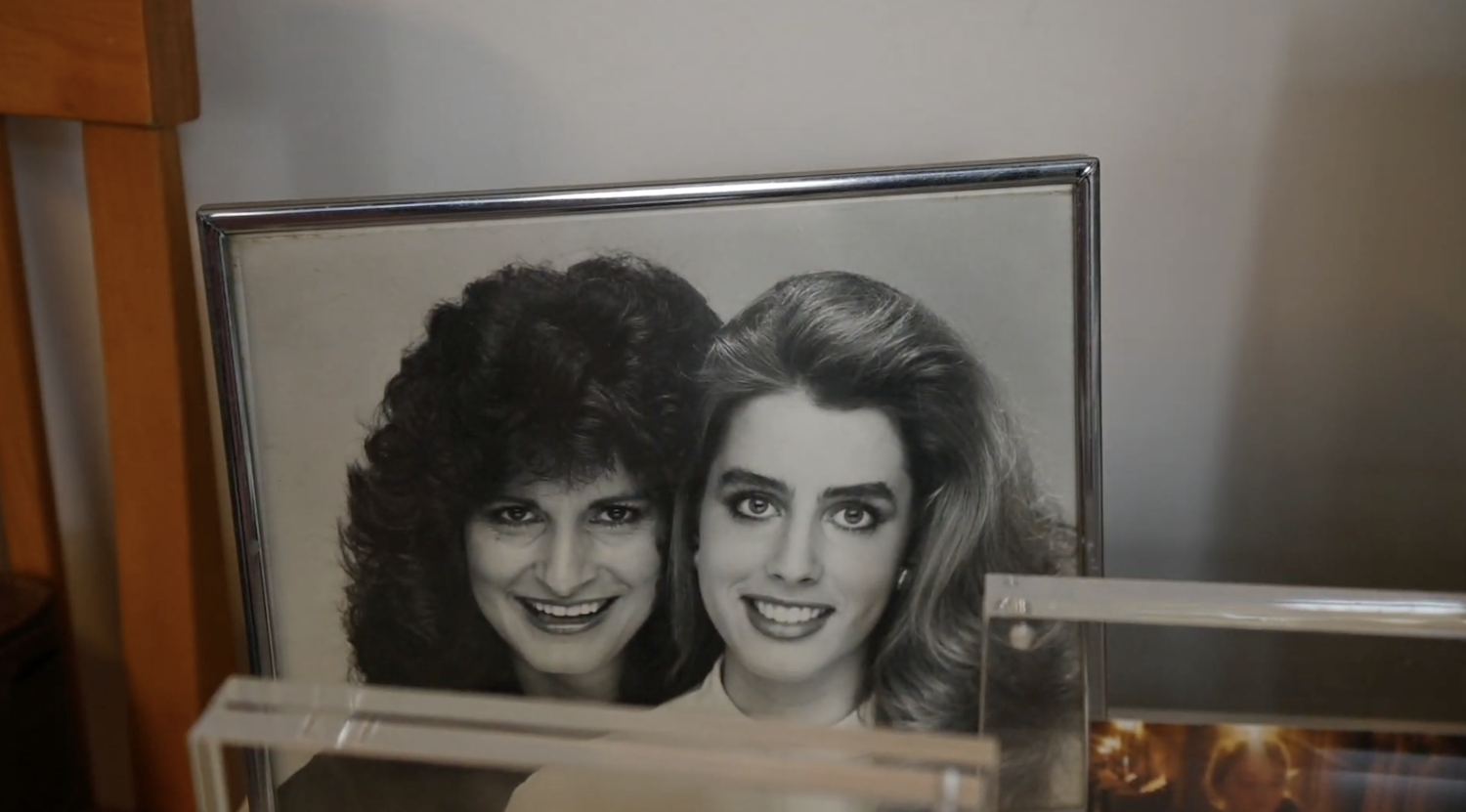 Two young women in a black and white photograph smiling